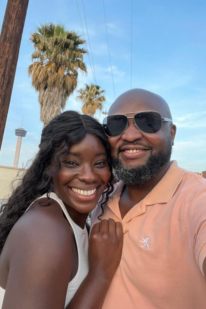 Beautiful black couple smiling into the camera while taking a selfie together