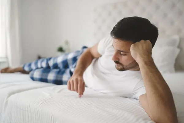 young man laying on the bed