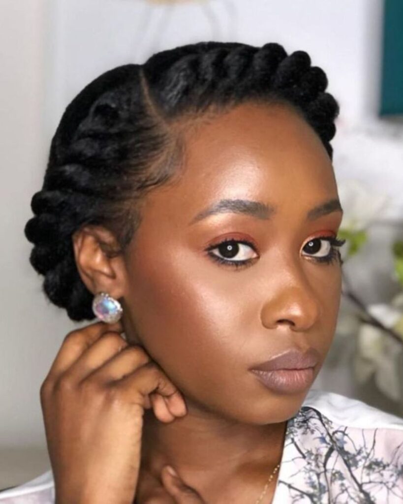 young black woman looking to the side while showing off her halo braid on her natural 4c hair