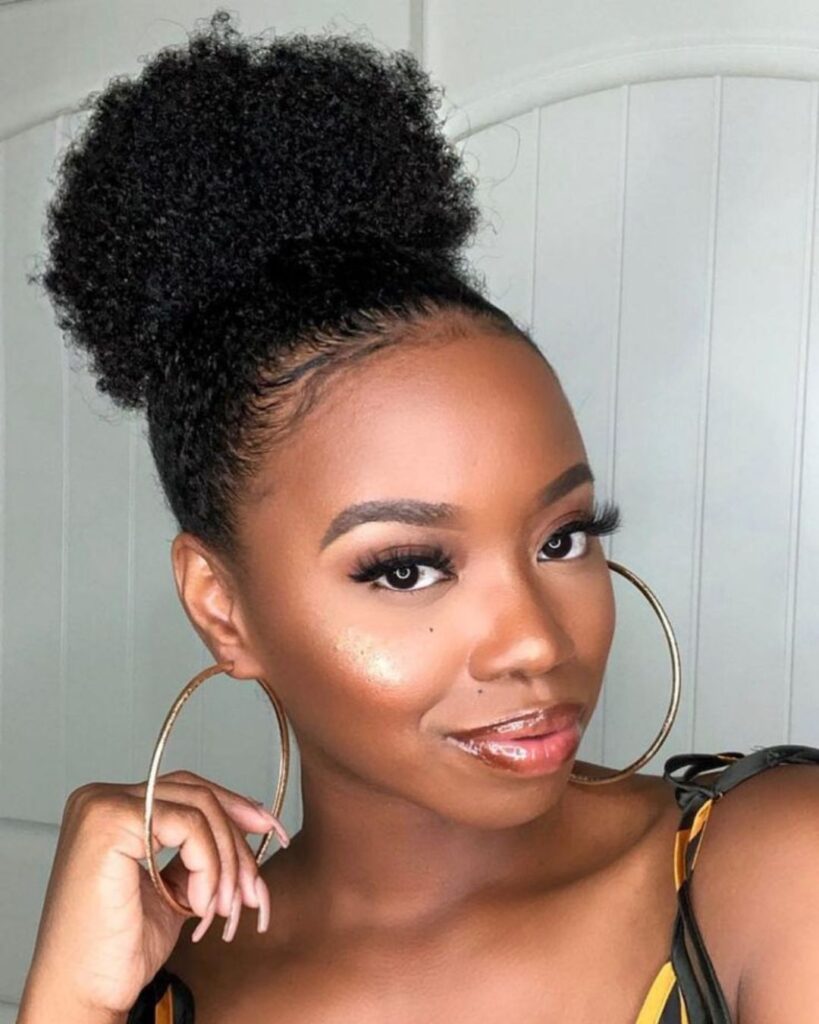 beautiful black woman showing off her high puff hairstyle