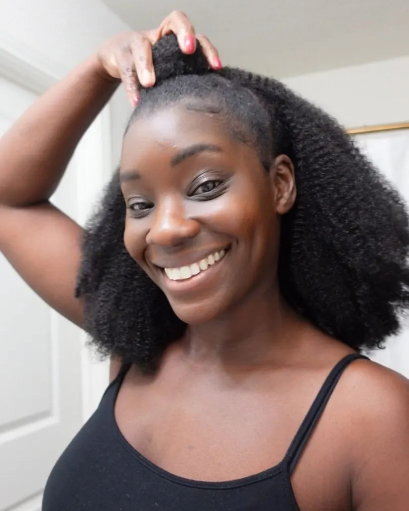 young black woman with half up half down 4c hair