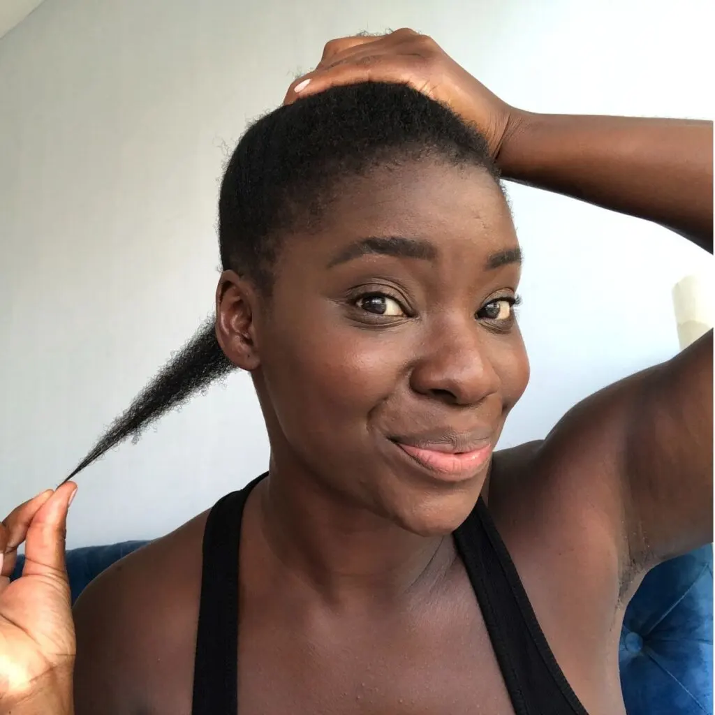 young black woman showing off her 4c hair growth