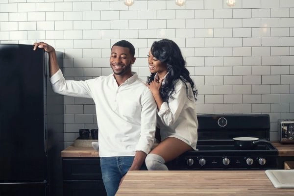 young black couple talking in the kitchen