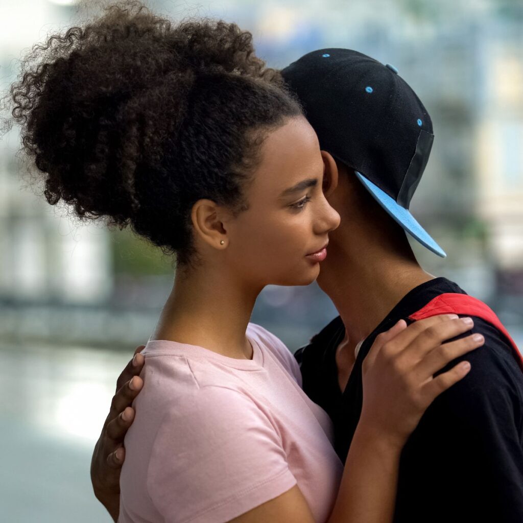teenage couple hugging