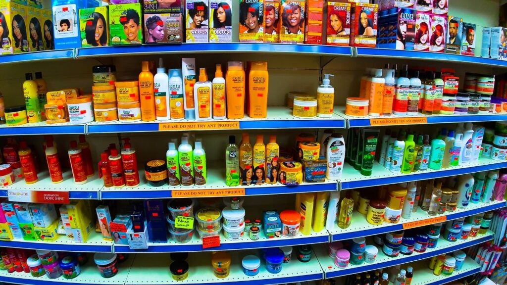 multiple shelves in a supermarket filled with black hair products