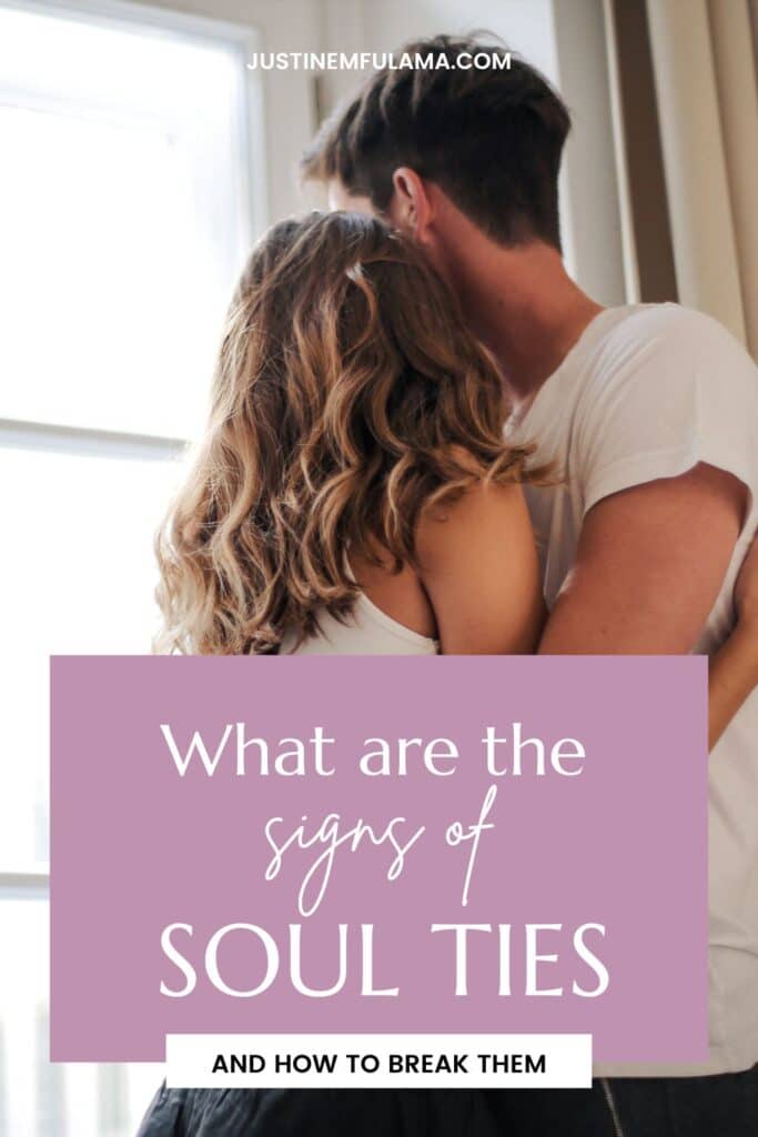 young couple holding each other wile looking out the window