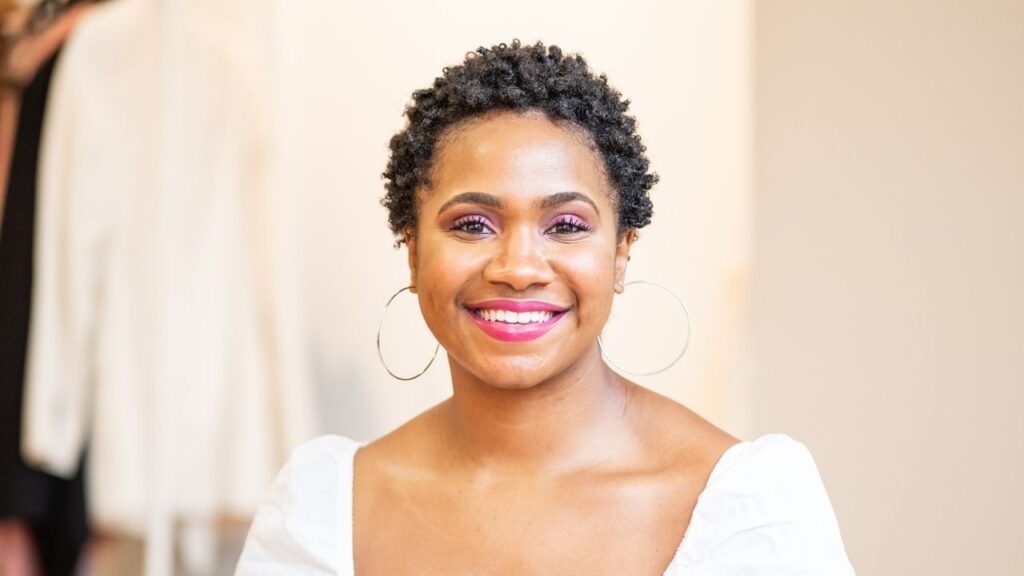young black woman with short natural hair smiling into the camera