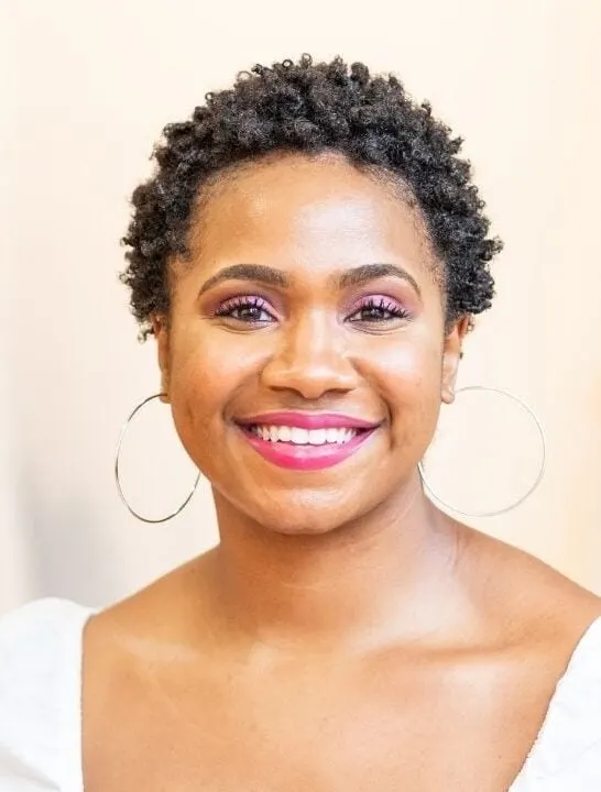 young black woman with short natural hair smiling into the camera