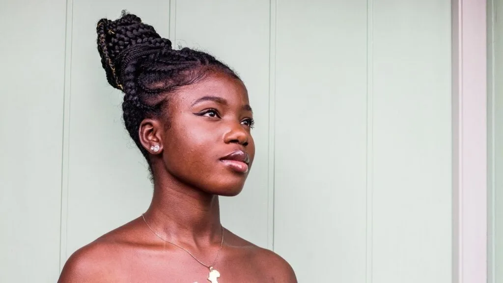 black woman with box braids looking into the distance