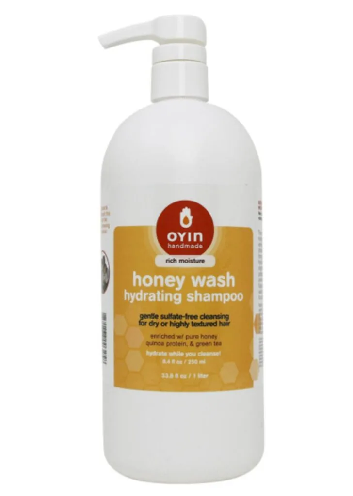 bottle of OYIN shampoo in front of a white background 