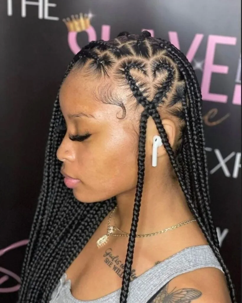 side profile of young woman with knotless braids with a heart on the side