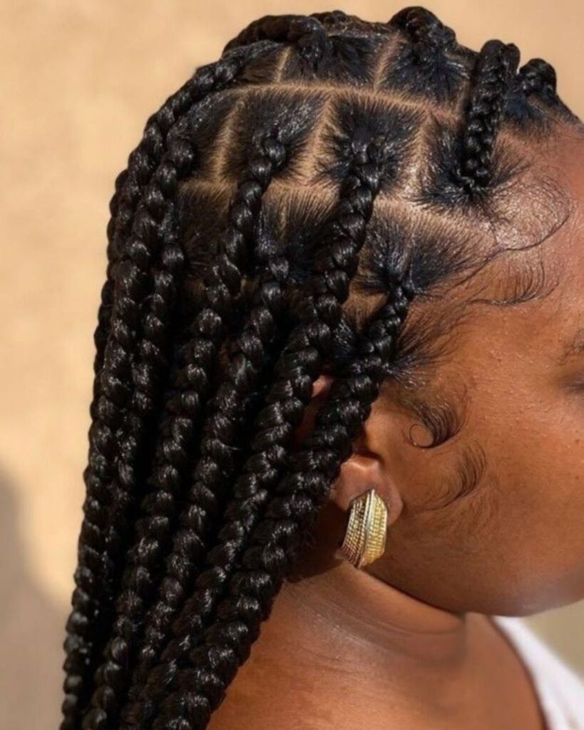 Side profile of black with large Knotless Braids