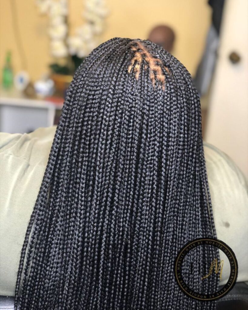 black woman in a salon with micro knotless braids