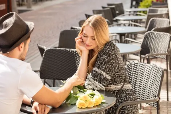 man and woman sitting at a patio of a restaurant