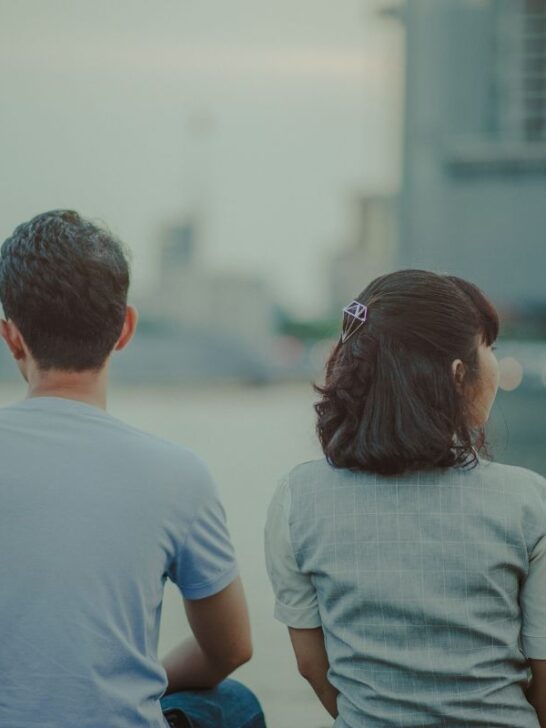 young couple sitting at the pier