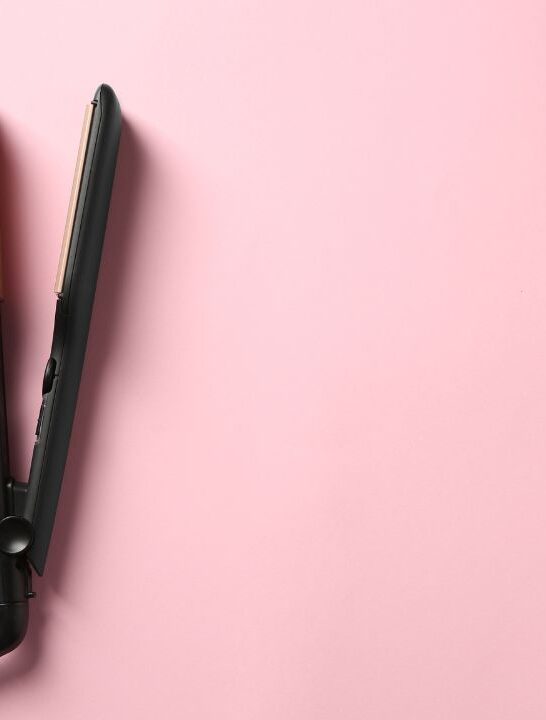 black flat iron against pink backgrouns