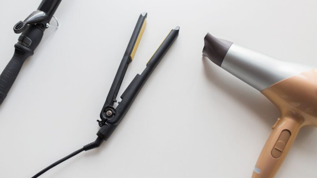 heat-styling tools laying on table