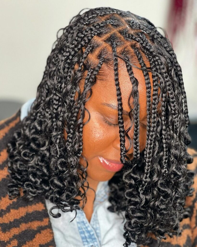 Black woman showing off her short boho braids