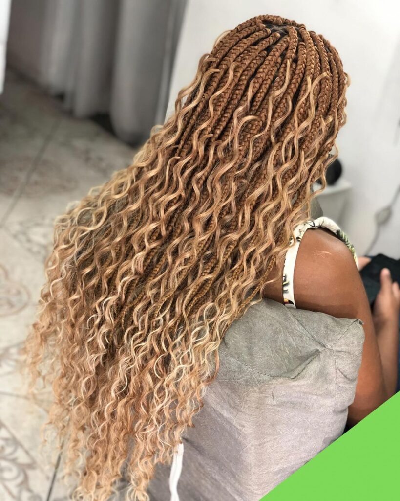 black woman in salon chair with long blonde goddess box braids