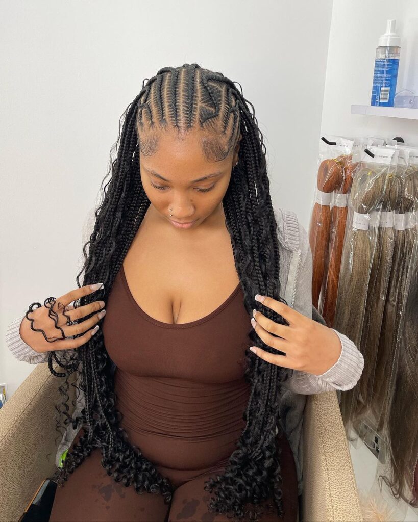 young black woman in salon chair with half cornrows half box braids