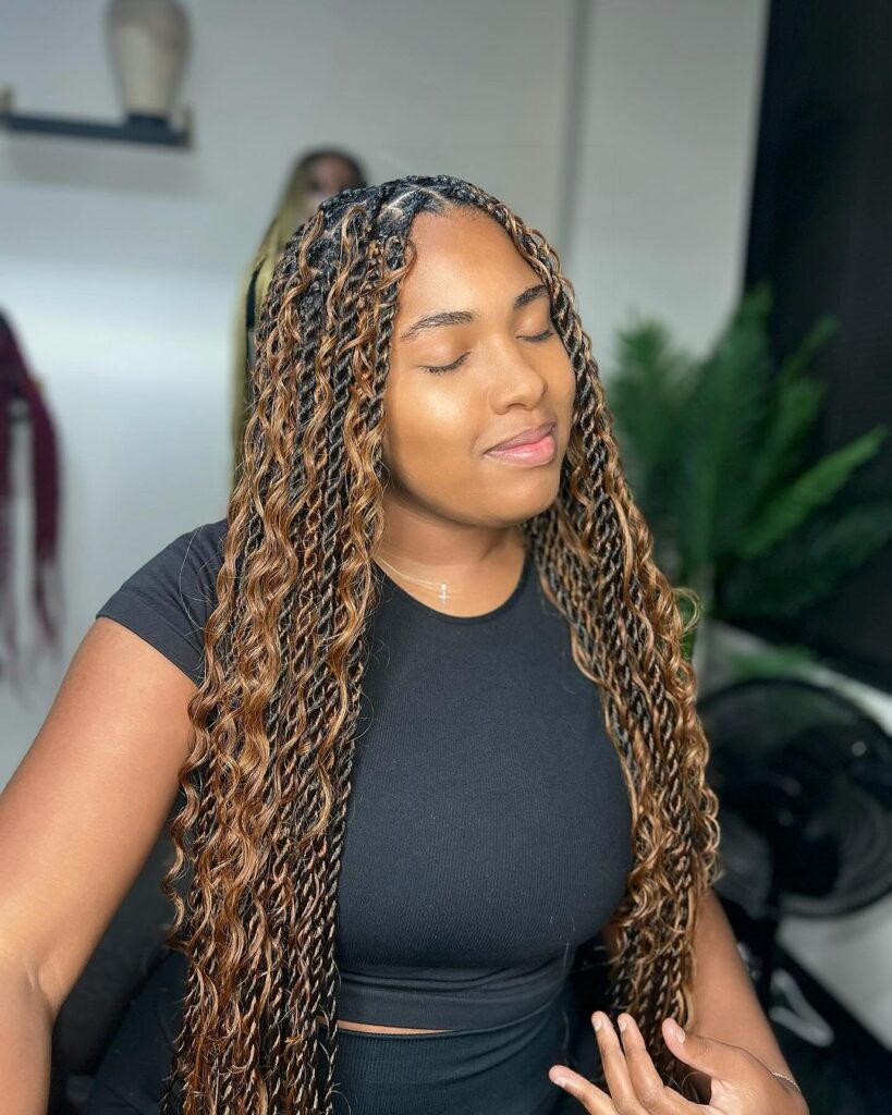 young black woman in salon with island twist in black and brown